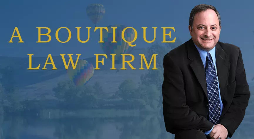Steve Bliss at a lake with hot air balloons in the background, the words, a boutique law firm are prominently displayed over the image.